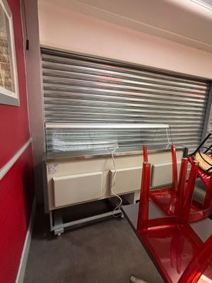 a room with a table, chairs, and a window