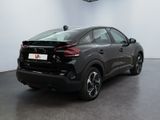 the rear end of a black honda hrx parked in a showroom