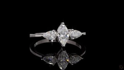 a close up of a diamond ring on a black surface