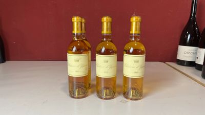 quatre bouteilles de vin sont alignées sur un comptoir