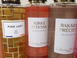 several bottles of perfume are lined up on a table