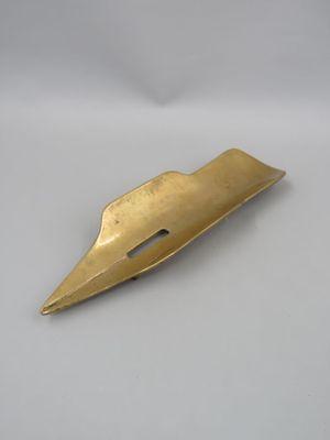 a close up of a metal object on a white surface