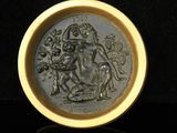 an image of a gold plate with a picture of a man on a horse
