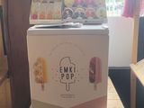 a box of ice cream sitting on top of a wooden table