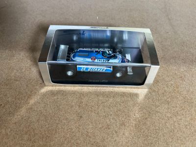 a model of a car in a box on the floor