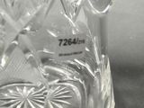 a clear glass pitcher with a handle on a table