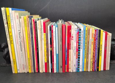 a lot of books that are stacked together on a table