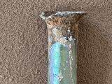 an old pipe with a hole in it sitting on the floor