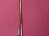 a close up of a pool cue on a pool table