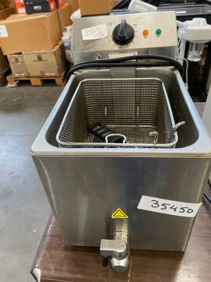 a close up of a fryer sitting on top of a wooden table