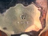 a close up of a silver plate on a wooden table