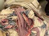 a pile of clothes sitting on a chair in a room