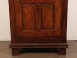 a wooden cabinet with a clock on top of it