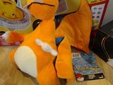 two stuffed animals sitting on a table next to a box of toys