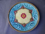 a decorative plate with a flower on it on a table