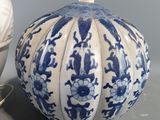 a blue and white vase and a lamp on a table