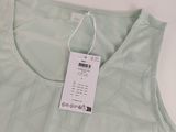 the back of a green tank top with a tag on it
