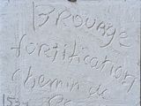 a plaque on the wall of a building with writing on it