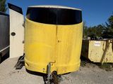 a bike parked next to a trailer in a parking lot
