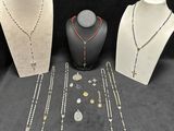 three necklaces, a necklace, and a necklace with a cross on it