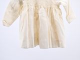 an image of a white dress hanging on a clothes rack