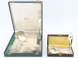 silverware in a case with a spoon and spoon rest in it