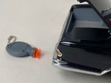 a cell phone and a keychain sitting on a table