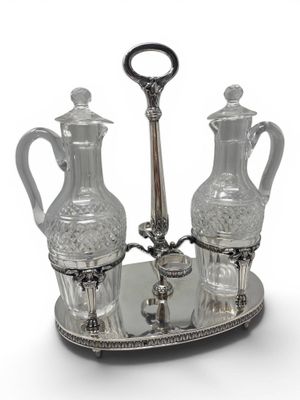 a silver tray with two glass vases on it