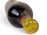 a bottle of wine that is sitting on a white surface