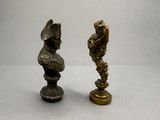 two bronze statues of a man and a woman on a pedestal