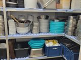 many dishes and pans on the shelves in the kitchen