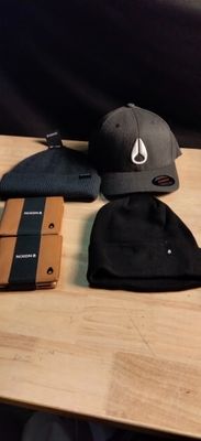 a wooden table with a hat, wallet, and other items on it