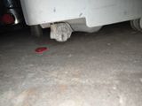a red object on the ground under a car