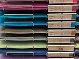 many folders stacked on top of each other in a store