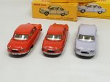 three toy cars are sitting next to each other on a table