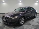 the audi is parked in a large room with a checkered floor