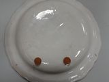 a white plate with orange dots on it on a table
