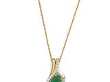 an emerald and diamond pendant on a gold chain