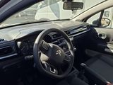 a car with a steering wheel and dashboard in a parking lot