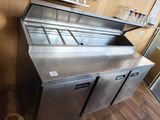 a stainless steel counter with a glass holder on top of it