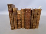 several old books are stacked on top of each other on a table