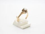 a close up of a gold ring with a diamond on top