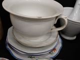 a stack of plates and cups on a table