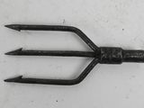 a small metal fork that is on a white surface