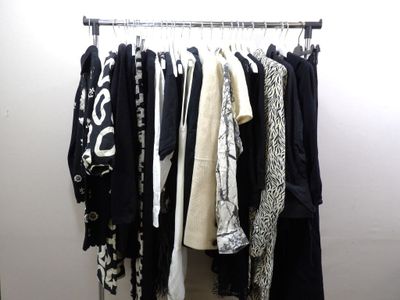 a rack of clothes hanging on a wall in a room