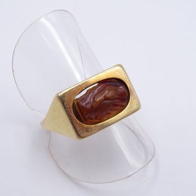 une bague en or avec une pierre de cornal au centre