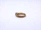 a close up of a gold ring on a white surface