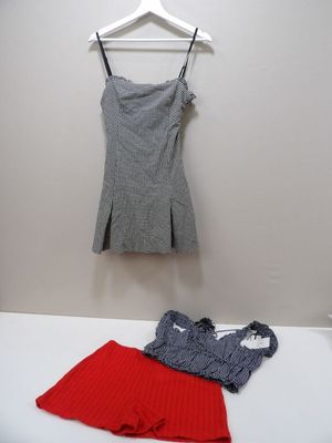 a white bed with a red skirt and a gray top