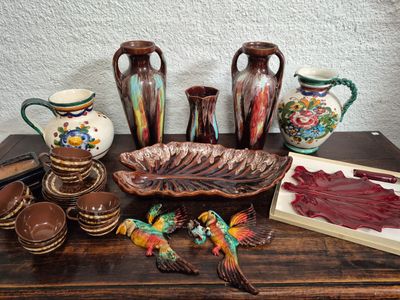 many different vases and bowls on a table