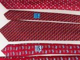 four red ties are lined up on a white surface